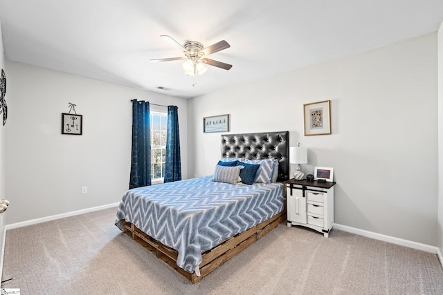 bedroom with a ceiling fan, light colored carpet, and baseboards