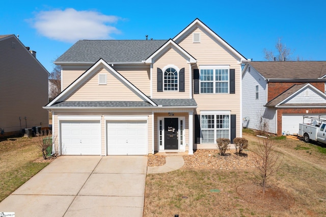 traditional-style home featuring a shingled roof, cooling unit, driveway, and a front lawn