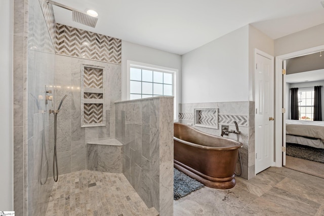 ensuite bathroom featuring a freestanding bath, tile walls, ensuite bathroom, and a walk in shower