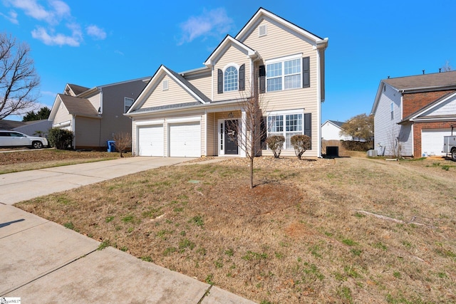 traditional-style house with driveway, a garage, and a front yard