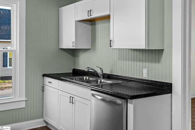 kitchen featuring a sink, white cabinets, a wealth of natural light, dishwasher, and dark countertops