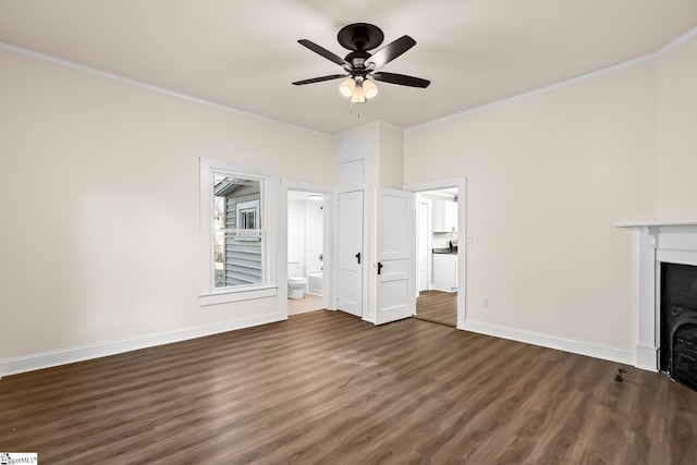 unfurnished living room with crown molding, a fireplace, dark wood-type flooring, a ceiling fan, and baseboards