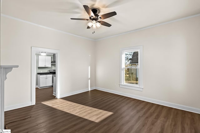 empty room with a ceiling fan, crown molding, baseboards, and dark wood-style flooring