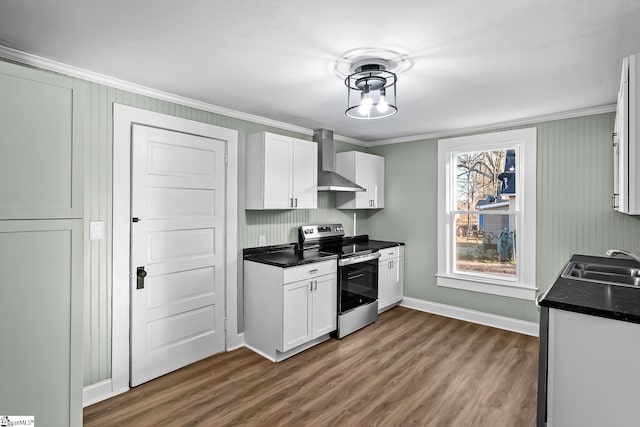 kitchen featuring dark countertops, a sink, wall chimney range hood, and stainless steel electric stove