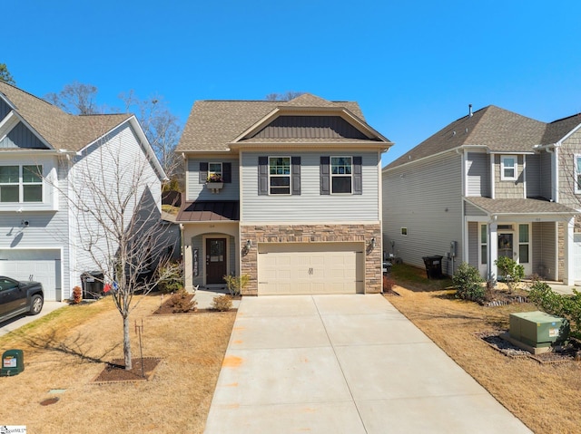 view of front of property featuring driveway, stone siding, an attached garage, a standing seam roof, and board and batten siding