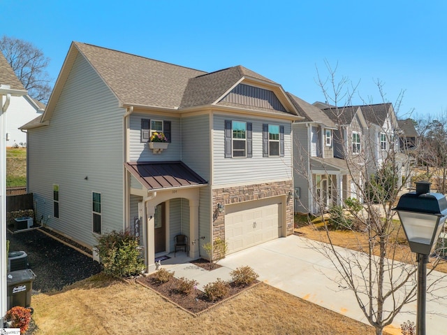 view of front of property featuring a garage, concrete driveway, stone siding, roof with shingles, and central air condition unit