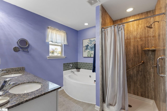 bathroom featuring visible vents, a sink, and a shower stall