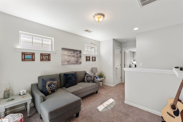 living area with light carpet, visible vents, and baseboards