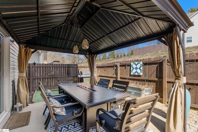 view of patio with a gazebo, outdoor dining area, a grill, and a fenced backyard