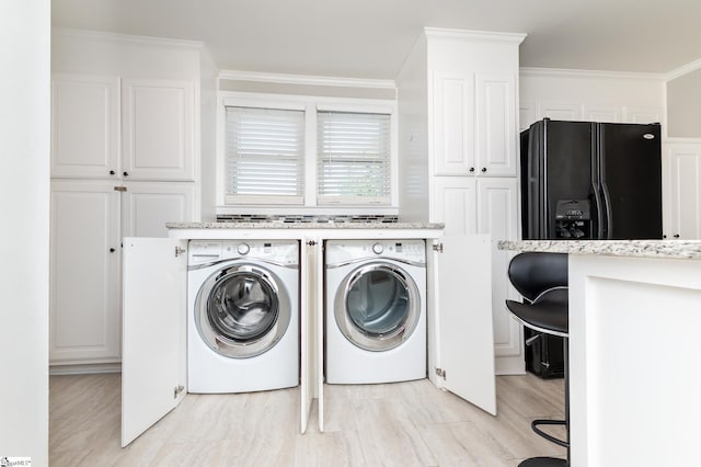 laundry room with laundry area, ornamental molding, and independent washer and dryer