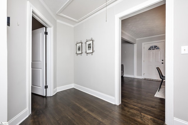 hall with ornamental molding, dark wood-type flooring, attic access, and baseboards