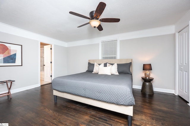 bedroom featuring ensuite bath, wood finished floors, and baseboards