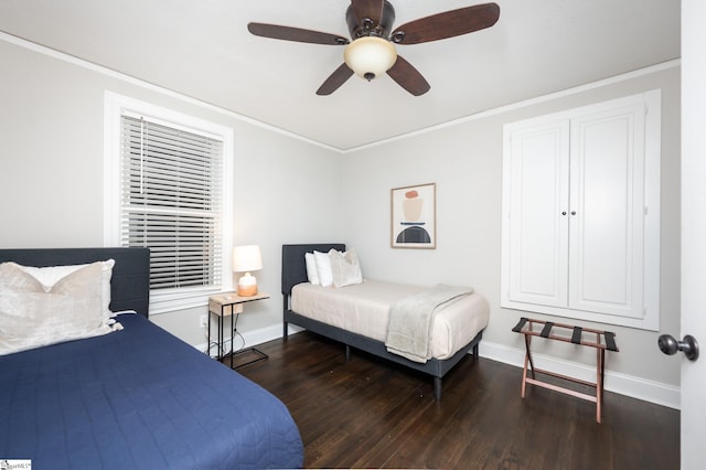 bedroom with ceiling fan, baseboards, wood finished floors, and ornamental molding