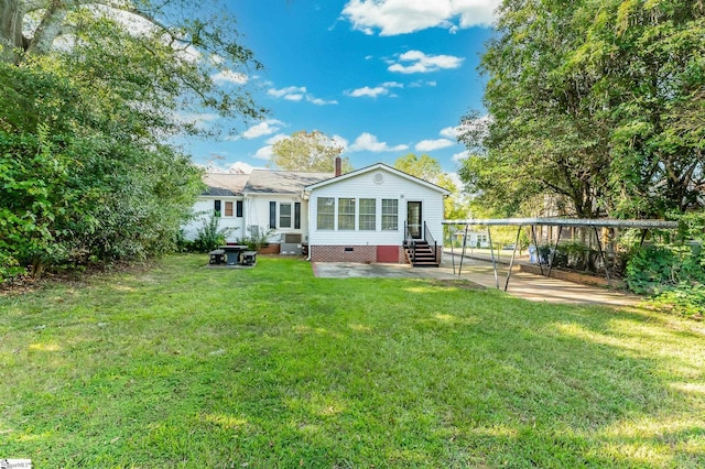 back of property featuring entry steps, cooling unit, a yard, crawl space, and a detached carport