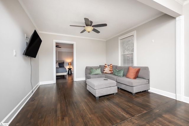 living area with crown molding, baseboards, and wood finished floors