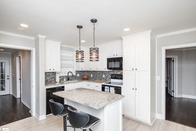 kitchen with crown molding, white cabinetry, a sink, and black appliances