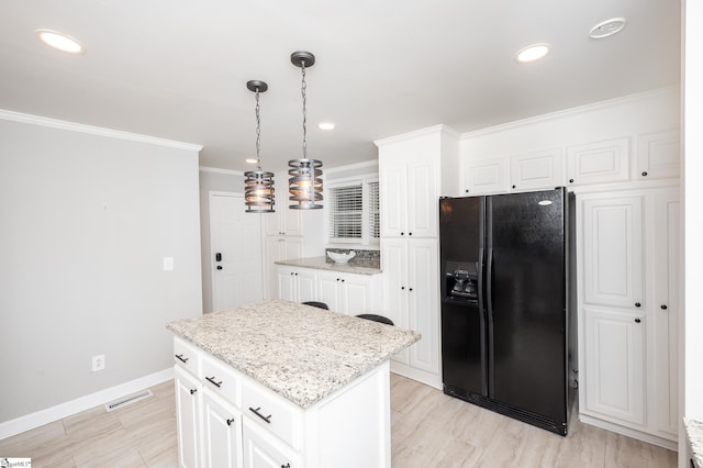 kitchen featuring black fridge with ice dispenser, ornamental molding, white cabinets, a kitchen island, and baseboards