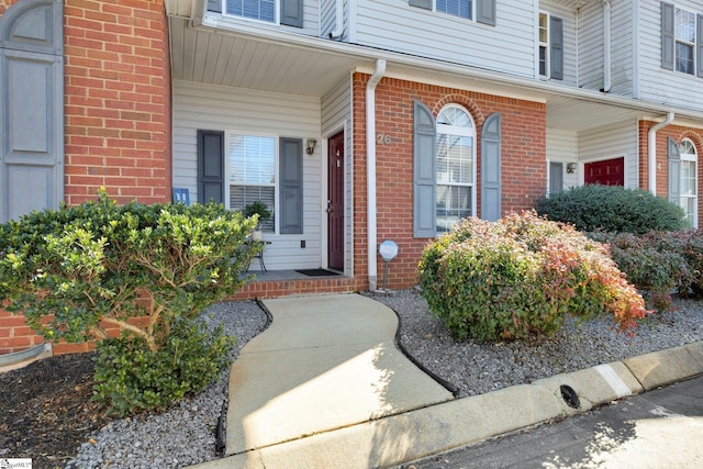 property entrance with brick siding