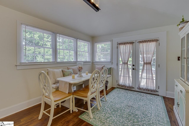 dining room featuring dark wood-style floors, french doors, and baseboards