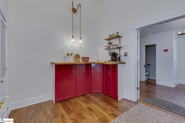 bar with baseboards and wood finished floors