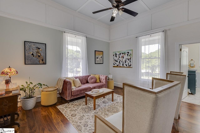 living area featuring dark wood-style floors, a healthy amount of sunlight, and a ceiling fan