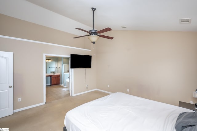 bedroom featuring light carpet, visible vents, baseboards, lofted ceiling, and ensuite bath