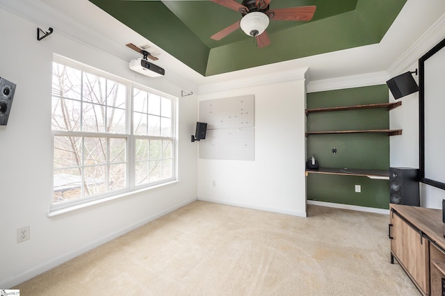 unfurnished bedroom featuring ornamental molding, multiple windows, a raised ceiling, and light colored carpet