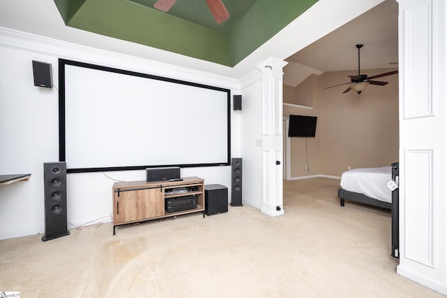 cinema room featuring vaulted ceiling, light carpet, ceiling fan, and decorative columns