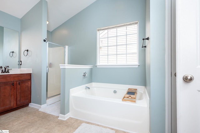 full bathroom featuring a garden tub, vaulted ceiling, a shower stall, vanity, and tile patterned flooring