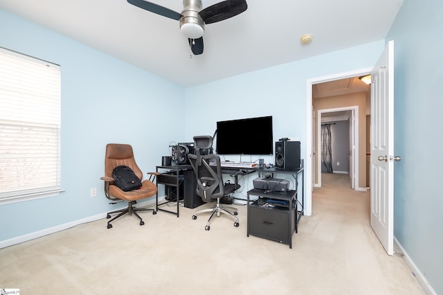 carpeted office space with ceiling fan, attic access, and baseboards