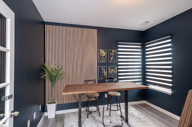 home office featuring visible vents, baseboards, and wood finished floors