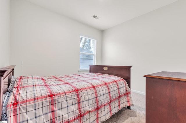 carpeted bedroom with visible vents and baseboards