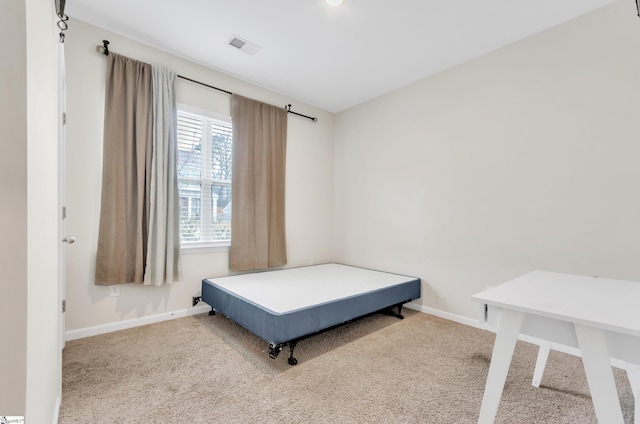 bedroom featuring carpet floors, visible vents, and baseboards