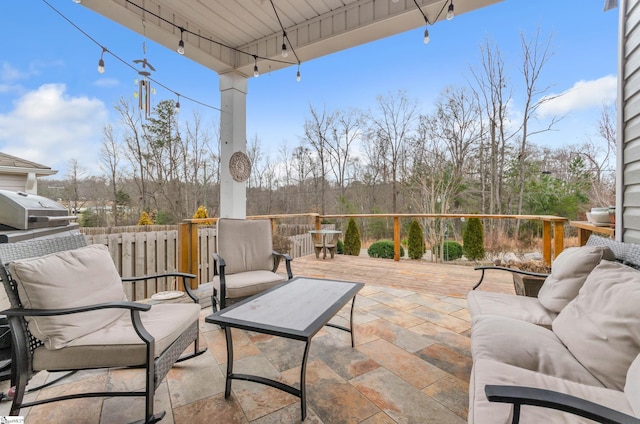 view of patio / terrace featuring a deck, a grill, and an outdoor living space