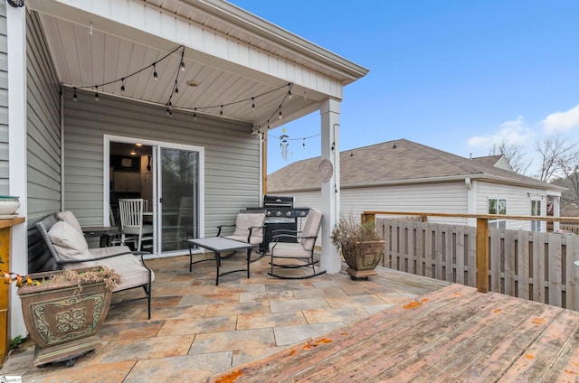 view of patio featuring fence and area for grilling