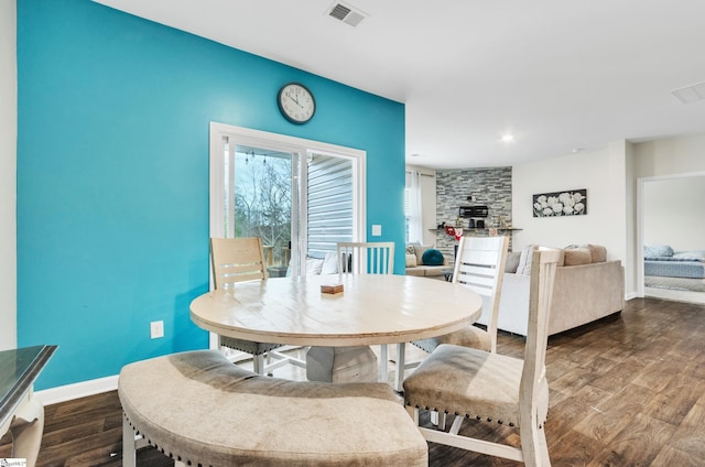 dining room featuring dark wood-style floors, baseboards, and visible vents