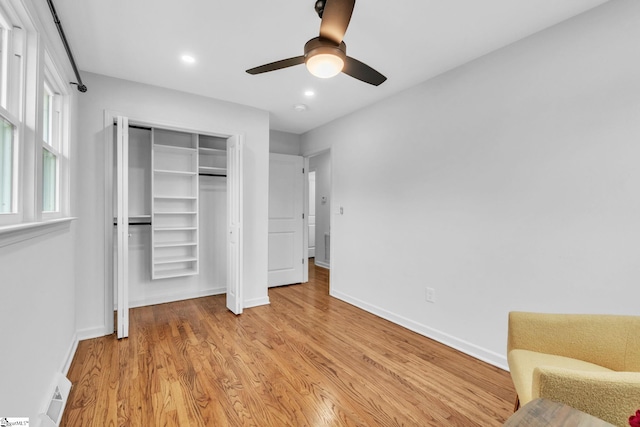 unfurnished bedroom with baseboards, a ceiling fan, light wood-type flooring, a closet, and recessed lighting