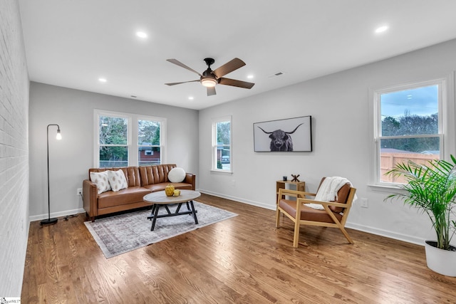 living area with recessed lighting, baseboards, and wood finished floors