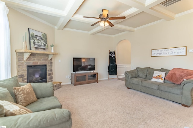 carpeted living room with visible vents, arched walkways, a ceiling fan, coffered ceiling, and beamed ceiling