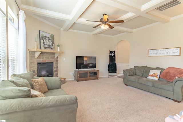 living area with carpet floors, arched walkways, visible vents, coffered ceiling, and beamed ceiling