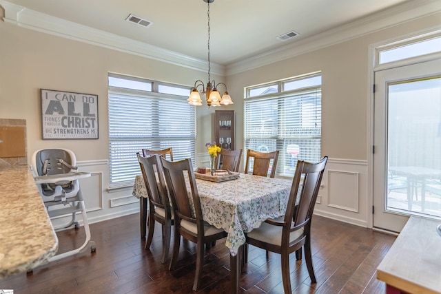 dining area with visible vents, a decorative wall, dark wood-style flooring, and ornamental molding