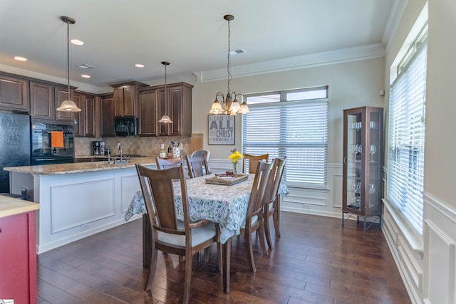 dining room with plenty of natural light, visible vents, and dark wood finished floors