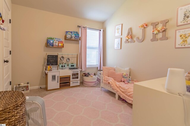 bedroom featuring light colored carpet and baseboards