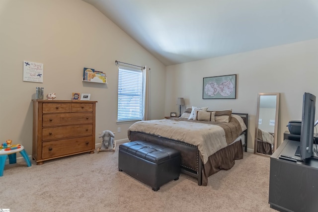 carpeted bedroom featuring lofted ceiling and baseboards