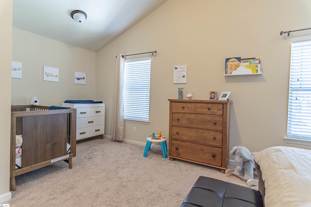 bedroom with lofted ceiling, baseboards, multiple windows, and carpet