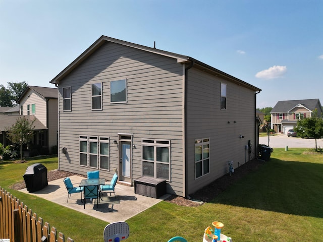 back of house featuring a patio and a lawn