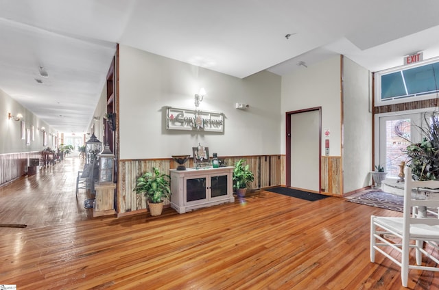 entrance foyer with hardwood / wood-style flooring and wainscoting