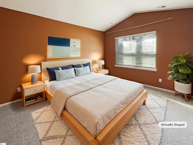 bedroom featuring lofted ceiling, carpet, visible vents, and baseboards