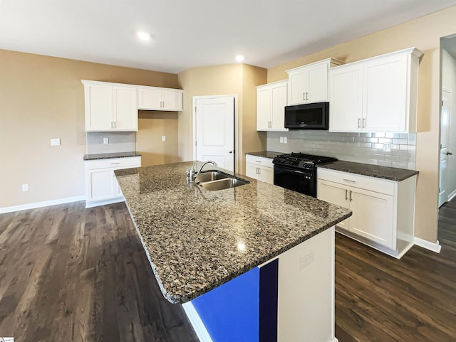 kitchen with tasteful backsplash, a sink, black appliances, and dark wood-style floors