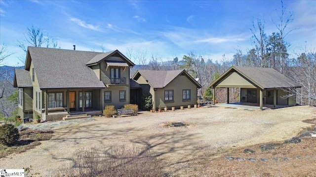 view of front of property with a balcony and driveway